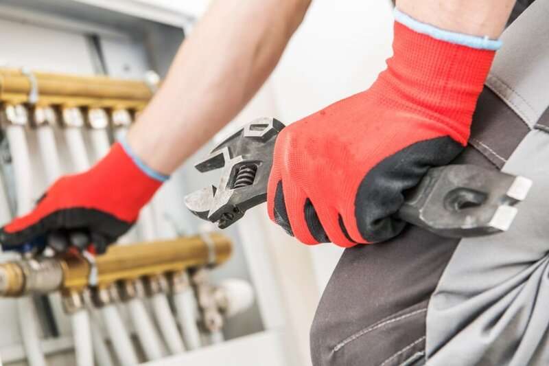 technician performing heating repairs